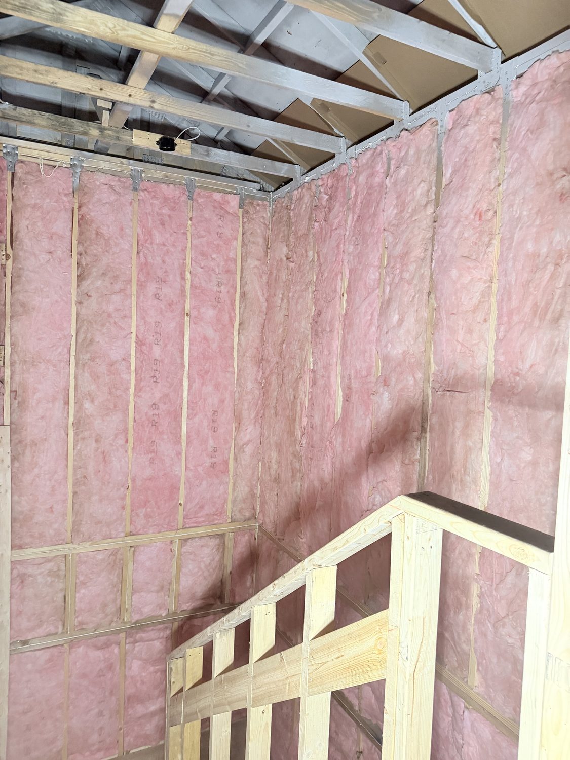 R-19 wall batt insulation around a stairwell